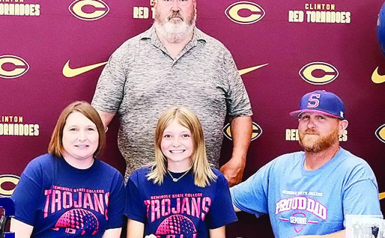 Clinton’s Rylee Cummins, center, is all smiles after signing to play college golf for Seminole State. Pictured with her, from left, is her mom Ashley Cummins, left, her dad Wade Cummins, right, and Seminole State Golf Coach Ronnie Williamson. CDN | Cour