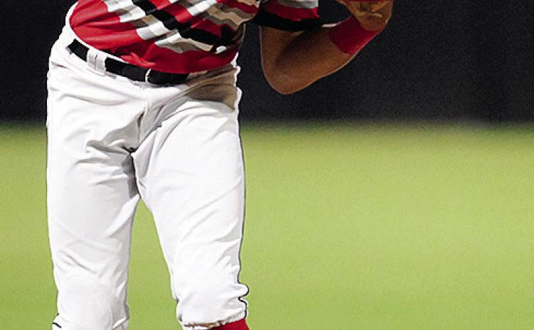 Caden Powell hurls the ball for the out during a game for the Fayetteville Woodpeckers