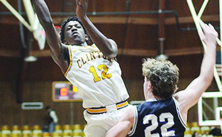 Clinton’s Atticus Thompson flies through the air for the layup during the Reds’ game against Bethany last year in the Tornado Dome. CDN | Sam Goodwyn