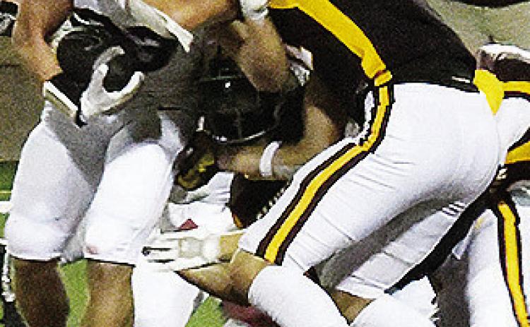 No. 81 Ben Daugherty takes down the Heritage Hall player during Clinton’s home opener Friday against the Chargers in the Tornado Bowl. CDN | John Kinsey