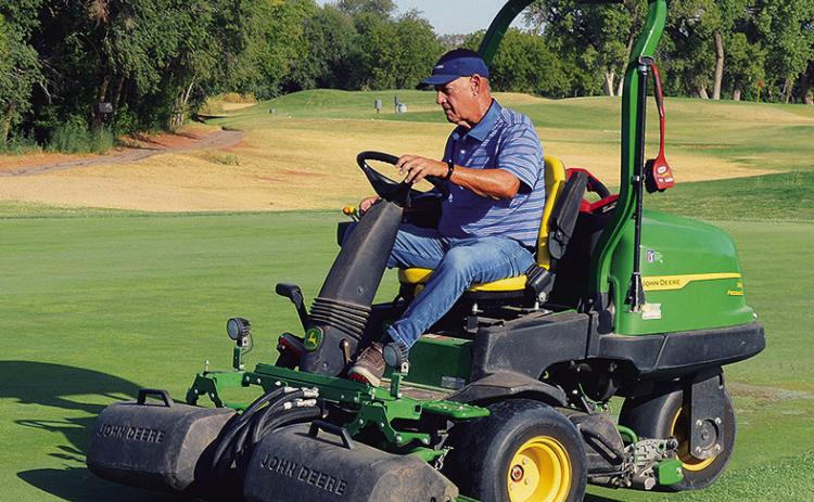 Kent Miller mows the greens and course of hole No. 17 Thursday at Riverside Golf Course. CDN | Christian Jacobsen