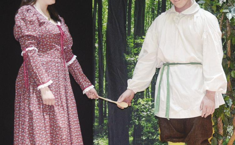 Lillian Miller as Lady Millicent Heaven-sent, left, has to share a wooden spoon weapon with Jaxon Slagell playing Little John in “The Somewhat True Tale of Robin Hood” at Corn Bible Academy. CDN | Christian Jacobsen