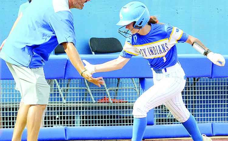 Arapaho-Butler’s Kylin Oakes, right, high fives Coach Luke Thompson as she rounds third during her home run trot which started the scoring for the Lady Indians against Caddo in the Class A State Championship game Saturday at Devon Park in Oklahoma City.