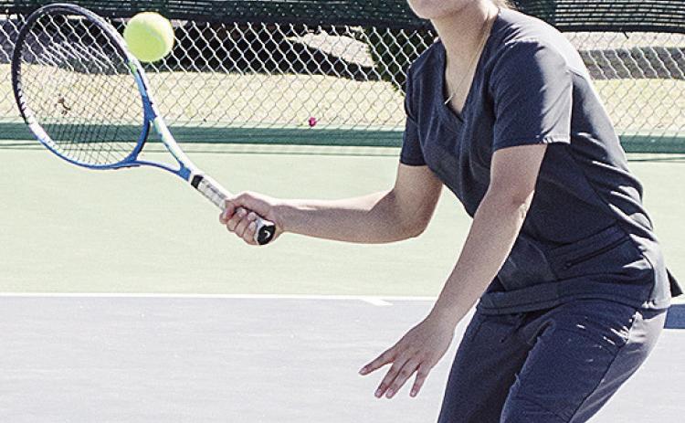 Clinton’s Idalia Pelayo focuses on the ball as she prepares to hit it turning tennis practice on the courts at the high school. CDN | Sam Goodwyn
