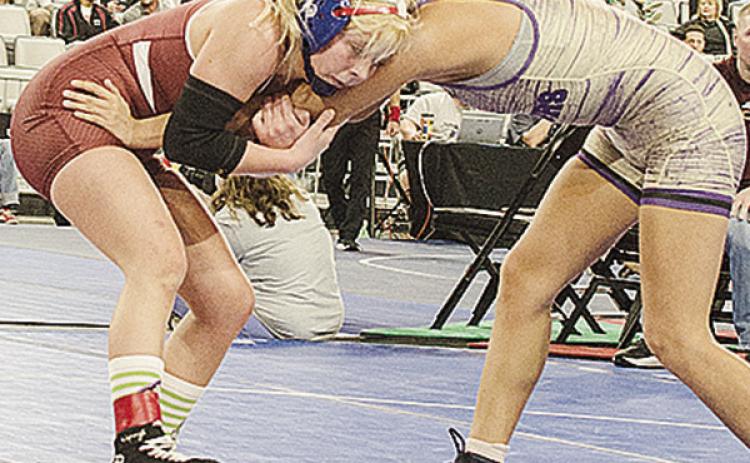 Clinton’s Baylor Moore, left, grapples with her opponent during the consolation semifinals of the Class 5A girls’ wrestling tournament Saturday morning at OG&amp;E Coliseum in Oklahoma City. CDN | Sam Goodwyn