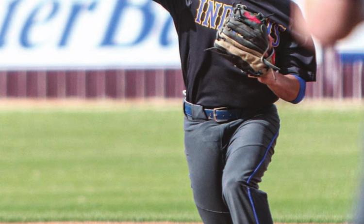 Eric Flores makes a throw to first base