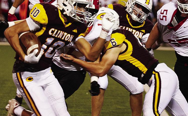 Clinton’s JJ Ruiz, left, carries the ball downfield while No. 6 Benton Bridgeman and Brayden Fuller provide blocks during the Red Tornadoes’ homecoming game Friday against Elgin in the Tornado Bowl. CDN | Micah Ashcraft