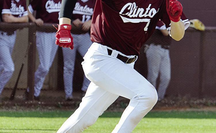 Clinton’s Chase Ray hustles to first during the Reds’ home game against Woodward. CDN | Sam Goodwyn