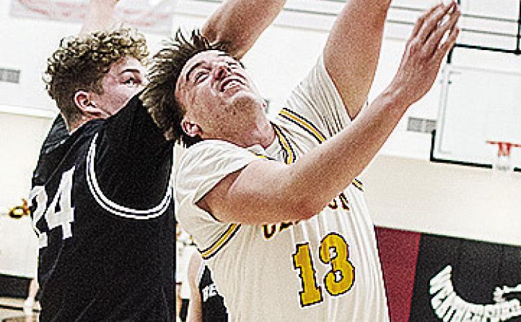 No. 13 Ethan Lofland gets around the defender for the layup during Clinton’s playoff game against Bethany Friday night in Weatherford. CDN | Sam Goodwyn