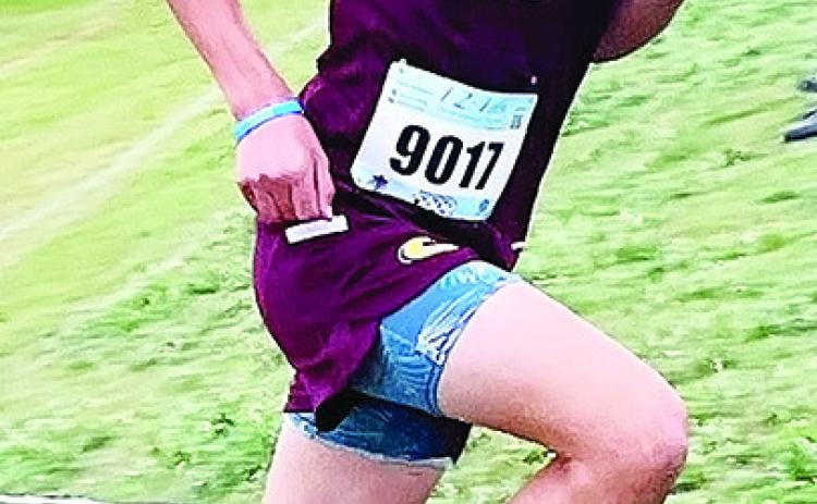 Clinton’s Scout Acosta runs uphill during the Kingfisher meet Saturday. CDN | Courtesy photo