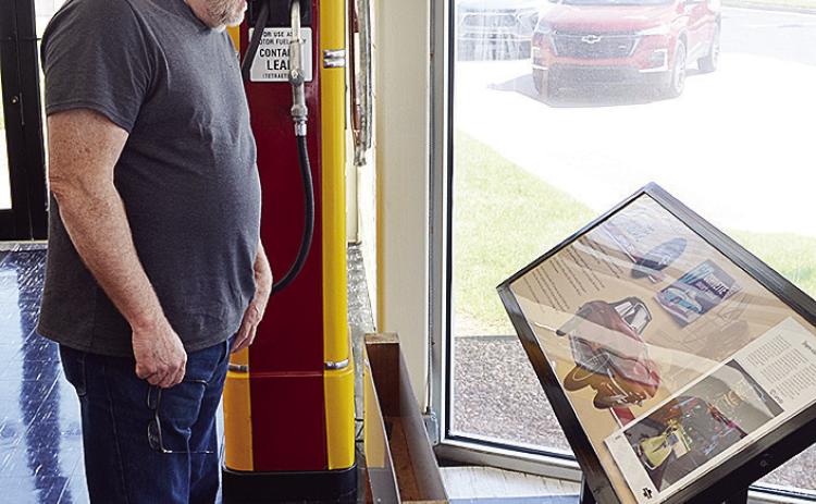 Dave Ketchum from St. Louis, Mo., examines the Corvette display Wednesday at the front of the Oklahoma Route 66 Museum. CDN | Sam Goodwyn