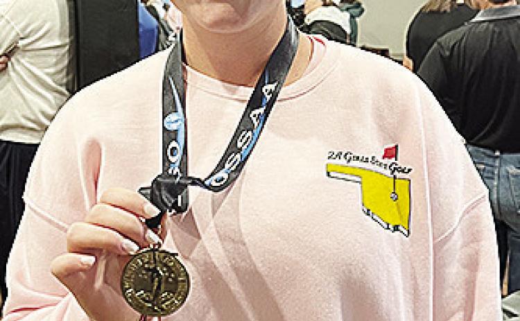 Corn Bible Academy’s Bentli Whitson shows off her medal after finishing ninth at the Class 2A State Tournament at Muskogee Country Club. CDN | Courtesy photo