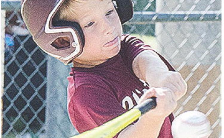 Clinton’s Timmy Sorter puts all of his strength behind his swing during the Reds’ first-round game of the OK Kids 8U Baseball State Tournament Thursday at Schumacher Fields at Acme Brick Park. CDN | Sam Goodwyn