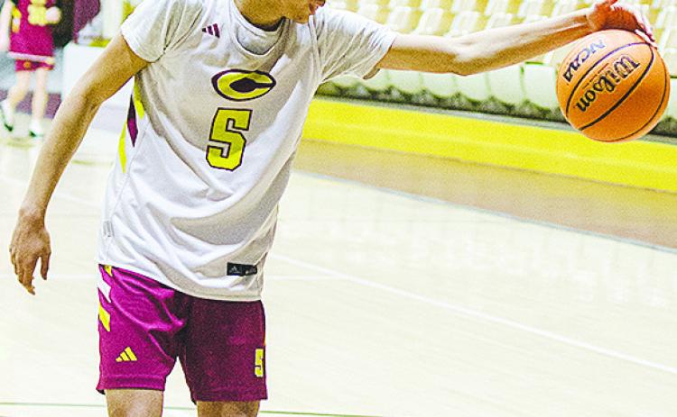 Clinton’s Kyron Forrest grabs the ball before it gets away from him during practice in the Tornado Dome. CDN | Sam Goodwyn