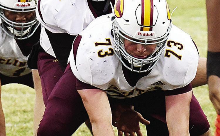 No. 73 Joel Badillo prepares to snap the ball to his quarterback No. 12 Sutton Hernandez in Oklahoma City during Clinton’s final regular season game against Douglass. CDN | John Kinsey