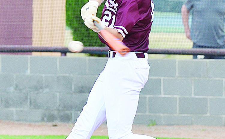 Clinton’s Ayden Crumley swings at the ball during the Reds’ home game Monday against Woodward. CDN | Sam Goodwyn