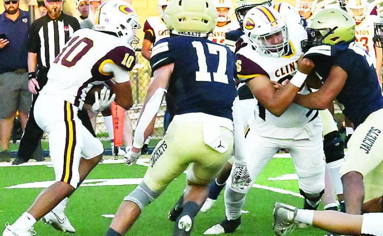 Clinton’s No. 10 JJ Ruiz carries the ball while Andre Lime, right, provides a block for him during the Red Tornadoes’ road game Friday against Kingfisher. CDN | John Kinsey