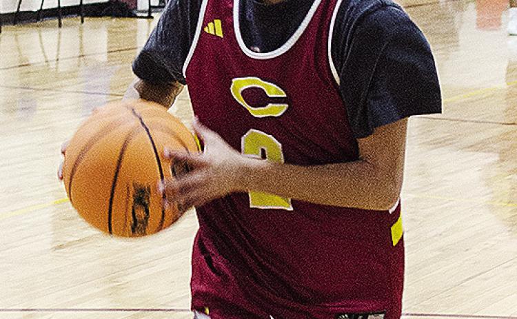 Clinton’s Ronnie Redshin focuses on the basket as he goes up for a layup during a practice in the gym at Southwest Elementary