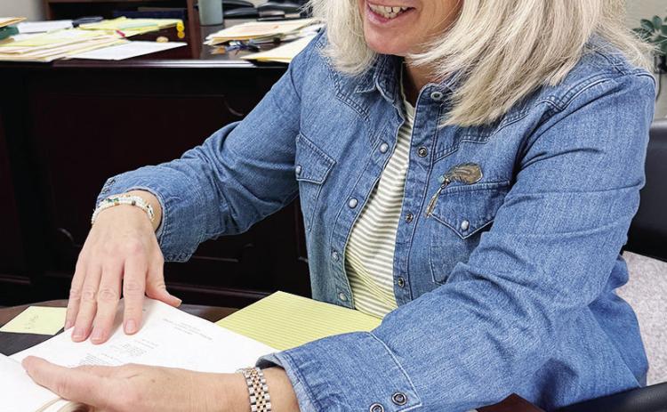 Jill Weedon goes over documents in her office. CDN | Shiann Dawson