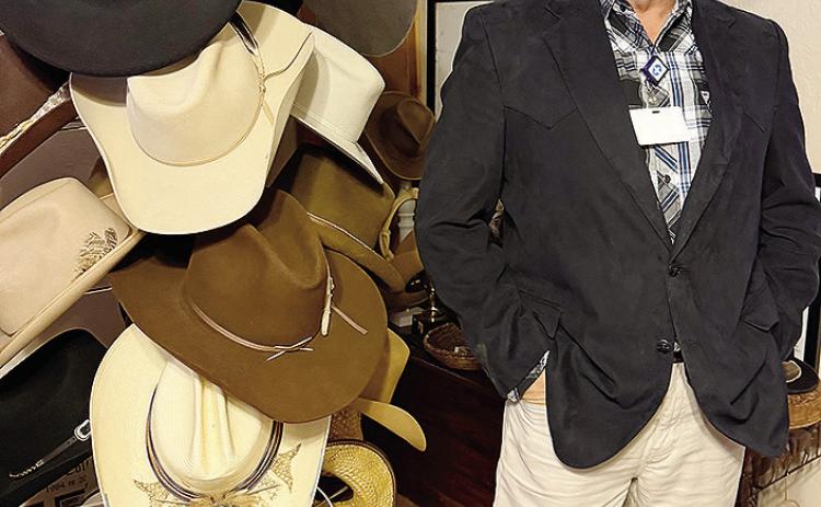 Wearing his favorite hat, Gary Albert stands next to a small portion of his collection. CDN | Shiann Dawson