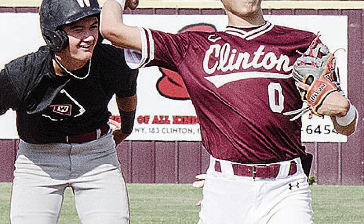 Clinton’s Declan Brown, right, throws the ball back to the pitcher after trying to keep the Weatherford runner at second during the Reds’ summer game against the Eagles. CDN | Sam Goodwyn