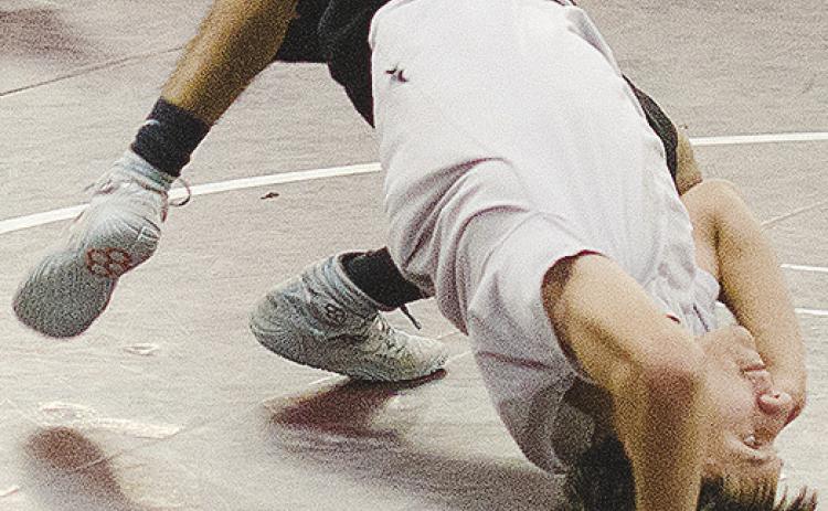 Brandon Rodriguez-Escalante bridges off his back during wrestling practice. CDN | Sam Goodwyn