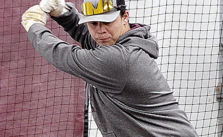 Reds senior baseball player Brady Chittum focuses on the ball during a hitting exercise at a recent practice. CDN | Sam Goodwyn