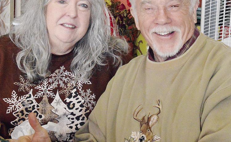 Tommie Walker and Bill Walker smile together as they enjoy a free meal during the H.O.S.T. Ministries’ Community Christmas Meal. CDN | Micah Ashcraft