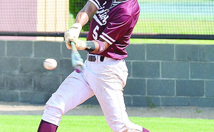 Clinton’s No. 5 Jesus Gutierrez swings at the incoming pitch during the Reds’ home win Thursday over Thomas. CDN | Sam Goodwyn