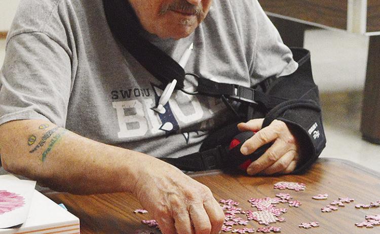Larry Wilmeth keeps his eye on the prize while working on a puzzle as one of the activities available at the Oklahoma Veterans Center. CDN | Micah Ashcraft