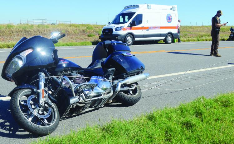 The rider of this motorcycle was thrown from the bike after it was tangled up in a power line around noon Thursday west of Clinton on State Highway 73. CDN | Christian Jacobsen