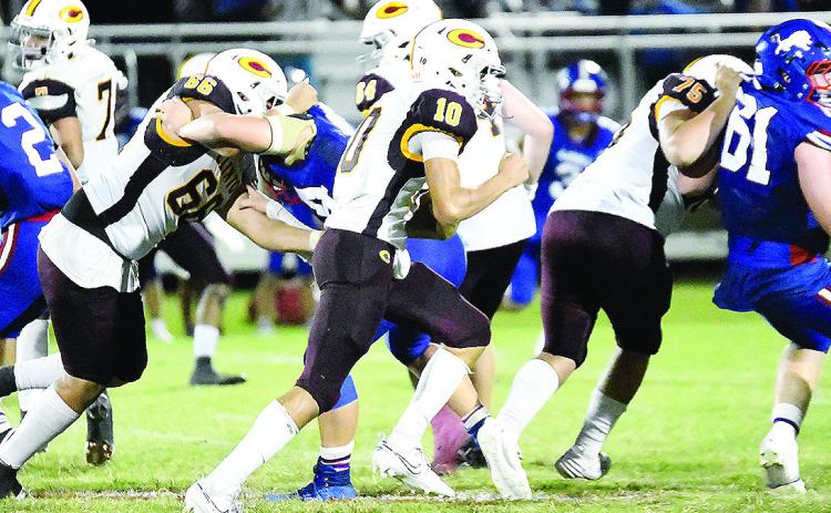 Clinton’s No. 10 JJ Ruiz carries the ball against Chandler Friday while No. 66 Andre Lime and No. 75 Eli Anderson provide blocks for him during the road game. CDN | John Kinsey