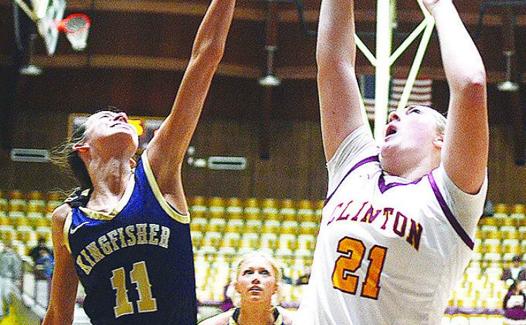 Clinton’s Rhylee Rodebush shoots the ball over a Kingfisher defender Saturday during the district round of the Class 4A Basketball Tournament at the Tornado Dome. CDN | Sam Goodwyn
