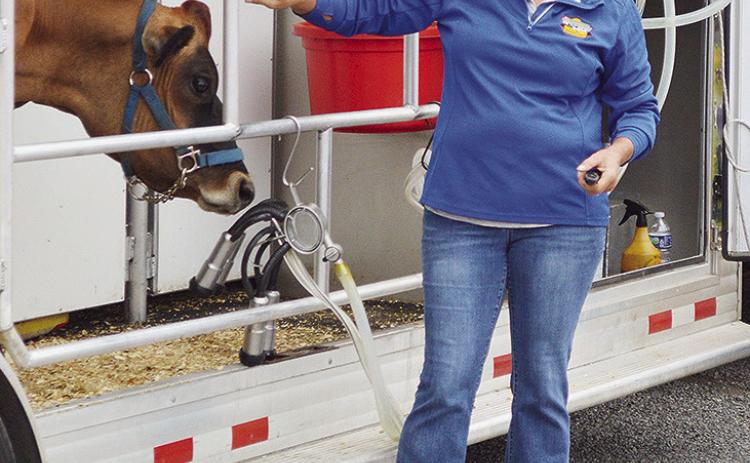 Suzie Reece teaches a group of students about dairy cows in a mobile dairy classroom during the Custer County Free Fair. CDN | Micah Ashcraft