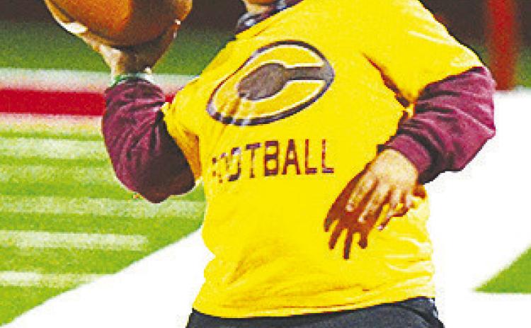 Kai Jefferson throws the football on the sideline during halftime of Clinton’s road game last week against Cache. CDN | Sam Goodwyn