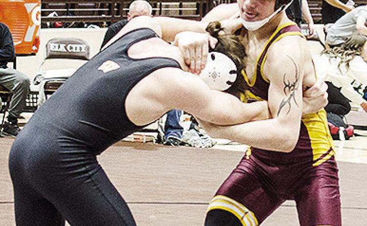Clinton’s Landon Wilson, right, grapples with his opponent during the Class 4A District Duals Tuesday in Elk City. CDN | Sam Goodwyn