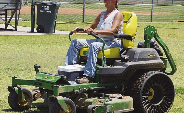 Sherrill Ausmus mows the grass at Schumacher Fields at Acme Brick Park Tuesday as the town prepares to host the OK Kids 8U Softball State Tournament starting today. CDN | Christian Jacobsen