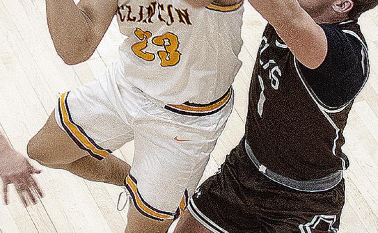 Clinton’s Easten Powell fights through the Elk City defender Thursday during the Reds’ win over the Elks in the Class 4A playoff game in Weatherford. CDN | Sam Goodwyn
