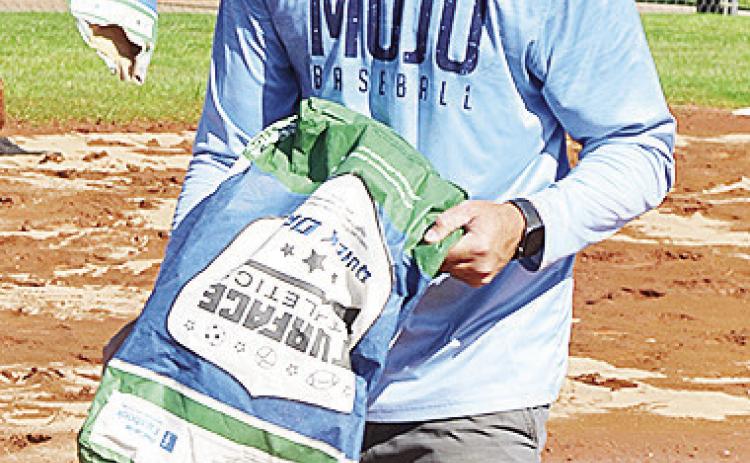 Kyle Serfoss adds dirt to the field Tuesday to help prepare for the 8U Softball State Tournament that will be held at Schumacher Fields at Acme Brick Park starting today. CDN | Sam Goodwyn