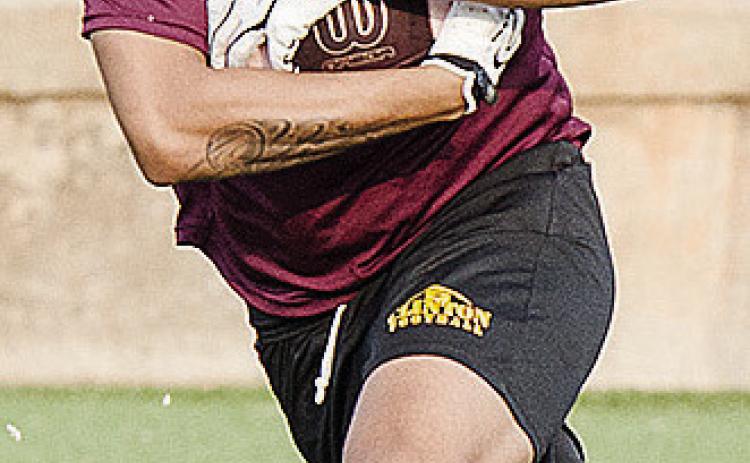 Cruz Rios holds onto the ball tight as he runs the ball during practice in the Tornado Bowl. CDN | Sam Goodwyn