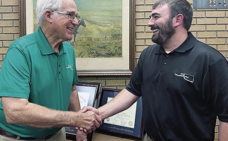 G.W. “Dub” Lowry, left, congratulates Tyler Freeburg on his recent promotion to president at Oklahoma Bank &amp; Trust. CDN | Shiann Dawson
