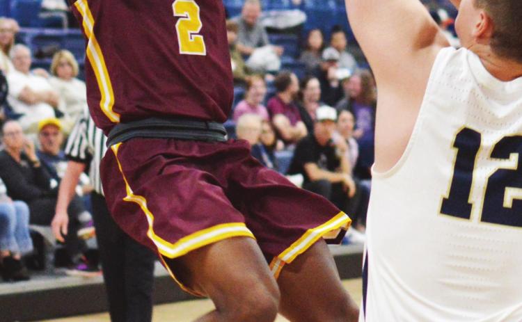 Clinton junior guard Atrel Bryson shoots a fadeaway jumper over a Kingfisher defender. Bryson recorded eight points and three assists in the loss to KF. CDN | Collin Wieder
