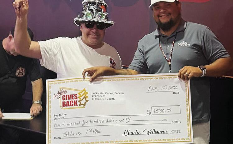 David Johnson, left, wins the St. Louis-style rib contest and is awarded $1,500 from General Manager Justin Twins at the Rib Cook Off Association Contest Saturday at Lucky Star Casino in Clinton. CDN | Courtesy photo