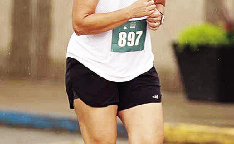 Newly-minted Clinton cross country coach Ashley Griffith runs down Frisco Avenue during the Clinton Classic Run this year. CDN | Courtesy photo