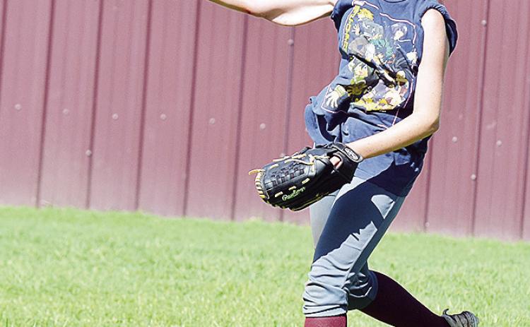 Clinton’s Madison Walker hurls the ball toward second base in a drill during practice. CDN | Sam Goodwyn