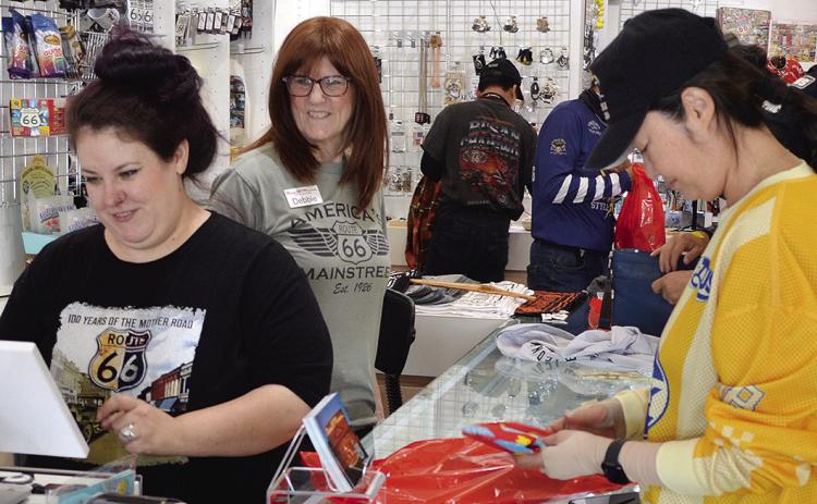 Khelsea Risinger, left, and Debbie Linderer, center, assist Joo Yeojin with her purchase Tuesday at the Oklahoma Route 66 Museum. Yeojin is on a trip with a larger group from South Korea. CDN | Christian Jacobsen