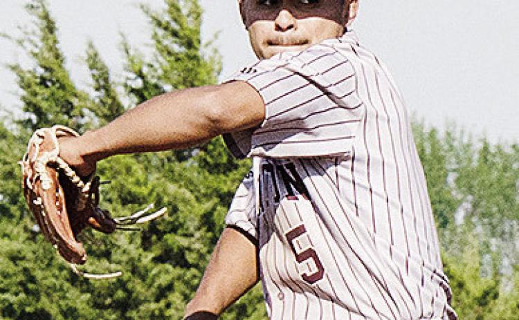 Clinton’s Jesus Gutierrez goes into his wind up as he prepares to pitch the ball during the Reds’ road win over Weatherford Monday in the “Custer County Conflict.” CDN | Sam Goodwyn