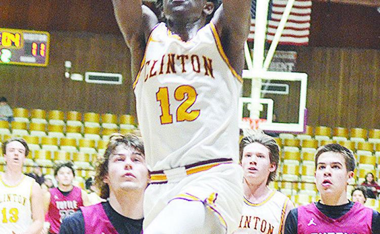 Clinton’s Atticus Thompson takes flight toward the basket during the Reds’ home win over the Tuttle Tigers Friday night in the Tornado Dome. CDN | Sam Goodwyn