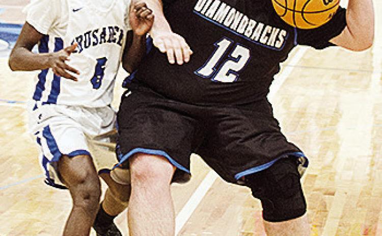 CBA’s Rolando Beadle guards the Olustee-Eldorado player as he tries to dribble the ball up the court in the Crusaders’ home win Thursday over the Diamondbacks. CDN | Sam Goodwyn
