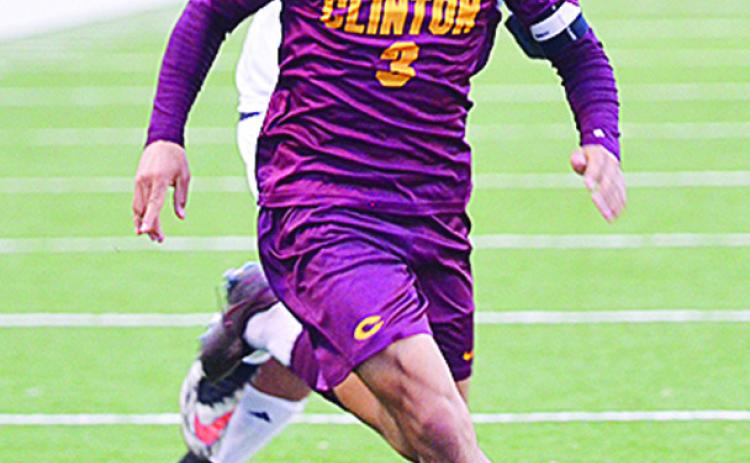 Clinton’s Carlos De La Fuente beats a Douglass defender to the ball during the Red Tornadoes win over the Trojans at home. CDN | Sam Goodwyn
